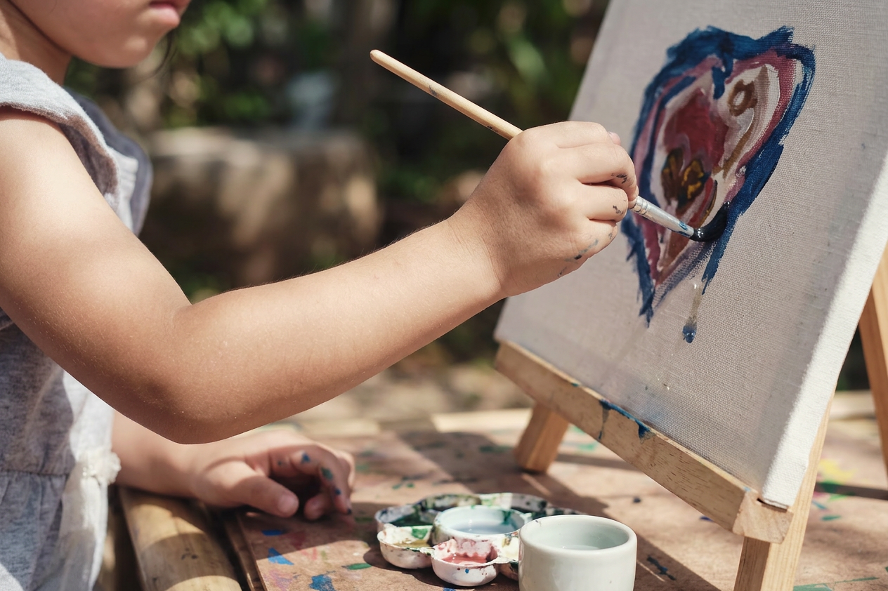Colorful art materials and youth-created painting